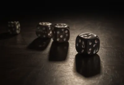 Dice caught mid-tumble and motion-blurred as they bounce across a bare dark board