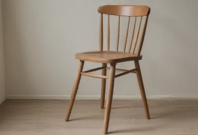 A plain wooden kitchen chair in a bare room.
