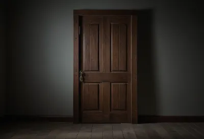 A tall empty wooden doorway set in a plain wall, seen straight on.